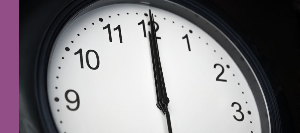 a clock face with the hands pointing straight up to the 12